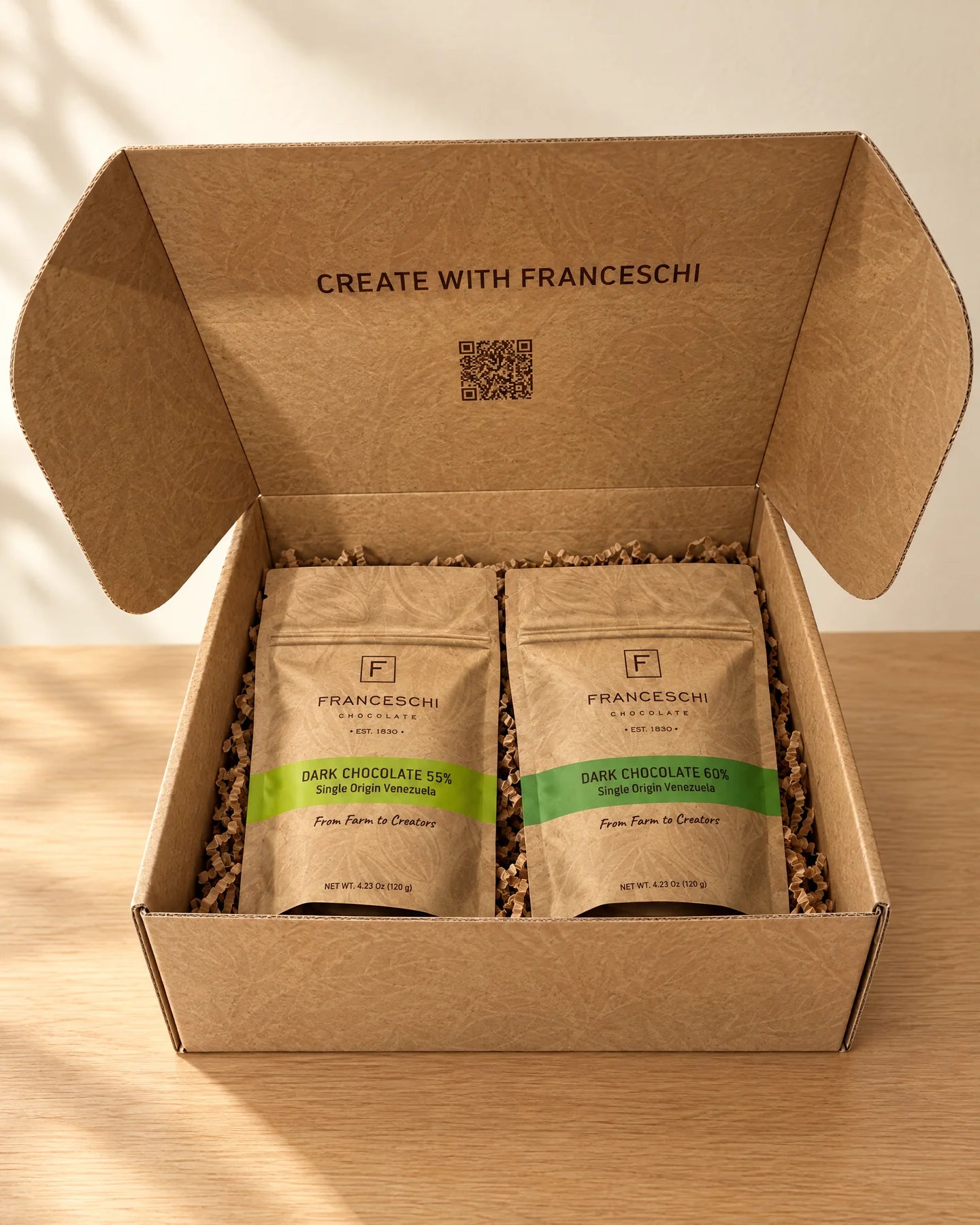 The Franceschi Discovery Kit box, seen straight on with the lid open, showing two 4.23 oz bags of Dark Chocolate 55% and 60%